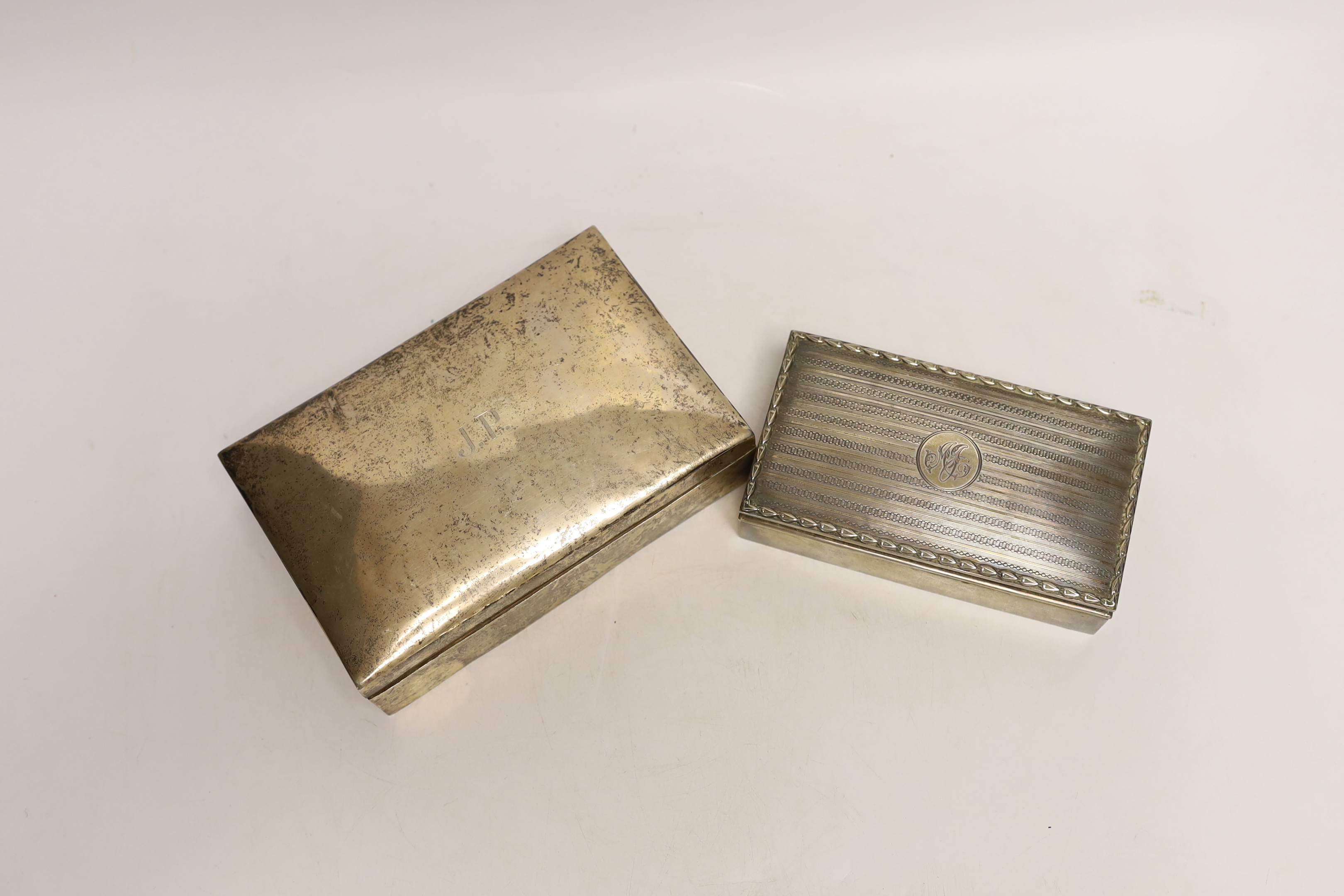 An Edwardian silver mounted rectangular cigarette box, by Synyer & Beddoes, Birmingham, 1908, 14cm, together with a larger Persian white metal mounted cigarette box.